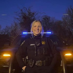 Beautiful Female Police Officer Patrolling the Night Streets